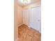 Hallway featuring tile floors and two white doors with gold hardware at 225 Loma Del Sol Dr, Davenport, FL 33896