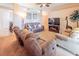 Cozy living room featuring plush seating, ceiling fan, and warm, inviting decor at 225 Loma Del Sol Dr, Davenport, FL 33896