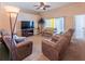Comfortable living room with recliners, a ceiling fan, and sliding glass door at 225 Loma Del Sol Dr, Davenport, FL 33896