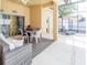 Cozy patio with comfortable seating, dining area, ceiling fan, and access to screened pool at 225 Loma Del Sol Dr, Davenport, FL 33896