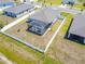 Birds eye view of a cozy home featuring a screened-in pool and backyard with a view of the community at 236 Aquamarine Ln, Kissimmee, FL 34758