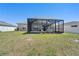Large backyard has a screened patio, white fence, and green grass at 236 Aquamarine Ln, Kissimmee, FL 34758