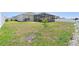 Large backyard features a screened-in porch and patchy green grass at 236 Aquamarine Ln, Kissimmee, FL 34758