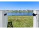 Gated backyard with scenic pond view and distant homes at 236 Aquamarine Ln, Kissimmee, FL 34758