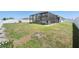 Spacious backyard with patchy grass and a screened-in patio at 236 Aquamarine Ln, Kissimmee, FL 34758