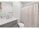Bathroom featuring a single sink vanity and a shower with curtain rod at 236 Aquamarine Ln, Kissimmee, FL 34758