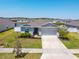 Aerial view of a single Gathering home with a well-kept lawn and two-car garage at 236 Aquamarine Ln, Kissimmee, FL 34758