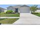 Charming single-story home with a well-manicured lawn and two car garage at 236 Aquamarine Ln, Kissimmee, FL 34758