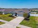 Aerial shot of a well-manicured home with neutral colors and a two-car garage at 236 Aquamarine Ln, Kissimmee, FL 34758