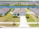 Beautiful single-story home near the water features well-maintained landscaping, a two-car garage, and a charming front yard at 236 Aquamarine Ln, Kissimmee, FL 34758