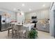 Kitchen with an island, stainless steel appliances, light-gray cabinets, and breakfast bar seating at 236 Aquamarine Ln, Kissimmee, FL 34758