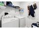 Bright laundry room featuring a washer, dryer, and ample shelving for storage at 236 Aquamarine Ln, Kissimmee, FL 34758