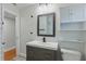 Bathroom features a grey vanity, wood look floors, and updated vanity lights and fixtures at 24 W King St, Orlando, FL 32804