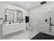 Modern bathroom features a walk-in shower with black fixtures and a double vanity with matching black hardware at 24 W King St, Orlando, FL 32804