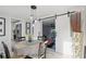 Bright dining room with modern lighting, table for four, and sliding barn door to the main bedroom at 24 W King St, Orlando, FL 32804