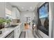 Modern kitchen with white cabinetry, stainless steel appliances, and stylish backsplash at 24 W King St, Orlando, FL 32804
