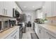 Modern kitchen with white cabinetry, stainless steel appliances, and stylish backsplash at 24 W King St, Orlando, FL 32804