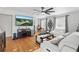 Bright living room boasts hardwood floors, stylish furniture, and a large flat screen television at 24 W King St, Orlando, FL 32804