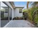 Side patio with gray stamped concrete, potted plants and sliding glass door at 24 W King St, Orlando, FL 32804