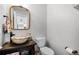 Bathroom with a unique vessel sink, dark wood vanity, and a toilet, providing a comfortable and practical space at 2424 Antlia Dr, Orlando, FL 32828