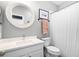 Bright bathroom featuring a round mirror, modern vanity with white countertop, and shower with a white curtain at 2424 Antlia Dr, Orlando, FL 32828