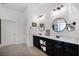 Bathroom featuring a double vanity with black cabinets and shiplap accent wall at 2424 Antlia Dr, Orlando, FL 32828