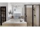 Bathroom with a soaking tub, glass shower enclosure, and decorative shelving at 2424 Antlia Dr, Orlando, FL 32828