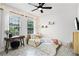 Airy bedroom with natural light, a desk, and decorative wall hangings at 2424 Antlia Dr, Orlando, FL 32828