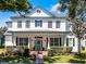 Charming two-story home with a welcoming front porch and beautifully landscaped front yard at 2424 Antlia Dr, Orlando, FL 32828