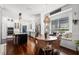 Open-concept kitchen and dining area with lots of natural light and hardwood floors at 2424 Antlia Dr, Orlando, FL 32828