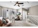 Upstairs living room with plush seating, natural light, and staircase at 2424 Antlia Dr, Orlando, FL 32828
