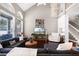 Bright living room featuring a vaulted ceiling, hardwood floors, and a view of the staircase at 2424 Antlia Dr, Orlando, FL 32828