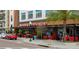 Outdoor dining at the Marketplace features bright red chairs, mature palm trees, and easy street access at 2424 Antlia Dr, Orlando, FL 32828