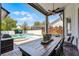 Covered patio with an outdoor dining table overlooking the pool and spa at 2424 Antlia Dr, Orlando, FL 32828