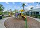 Community playground with colorful play structures, mature trees, and comfortable seating areas at 2424 Antlia Dr, Orlando, FL 32828