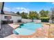 Beautiful backyard pool with a spa, basketball hoop, outdoor kitchen, and brick paver patio at 2424 Antlia Dr, Orlando, FL 32828