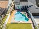 Aerial view of a backyard with a kidney-shaped pool, hot tub, outdoor seating, and well-manicured landscaping at 2424 Antlia Dr, Orlando, FL 32828
