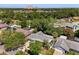 Wide aerial view of the home nestled among mature trees in a residential neighborhood at 2623 Parsley Dr, Orlando, FL 32837
