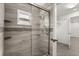 A bathroom featuring a glass shower door and tile walls at 2623 Parsley Dr, Orlando, FL 32837