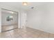 Bedroom featuring a mirror sliding door and tile floors at 2623 Parsley Dr, Orlando, FL 32837
