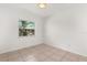 A bedroom has tile floors and a single window at 2623 Parsley Dr, Orlando, FL 32837