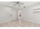 Bright bedroom featuring a tiled floor, ceiling fan, and an exterior door with access to the outside at 2623 Parsley Dr, Orlando, FL 32837