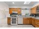 Bright kitchen with stainless steel appliances, oak cabinets, and a view of the backyard at 2623 Parsley Dr, Orlando, FL 32837