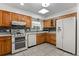 Well-lit kitchen featuring oak cabinetry, modern appliances, and ample counter space at 2623 Parsley Dr, Orlando, FL 32837