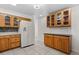 Functional kitchen with oak cabinets, tile backsplash, and a modern refrigerator at 2623 Parsley Dr, Orlando, FL 32837