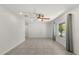 Spacious living room featuring large windows, tile floors, and a modern ceiling fan at 2623 Parsley Dr, Orlando, FL 32837