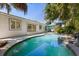 Backyard view of a pool with lounge chairs, a patio, tropical foliage, and the exterior of the home at 2623 Parsley Dr, Orlando, FL 32837