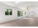 Sunroom featuring a tiled floor, skylight, windows, ceiling fan and sliding glass door with a view of the pool at 2623 Parsley Dr, Orlando, FL 32837