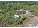 Aerial view of property showcasing treed lot with privacy fence, shed and home at 2651 Sunrise Blvd, Mount Dora, FL 32757
