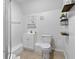 Bathroom featuring a shower, sink, toilet, shelves, and updated fixtures at 2651 Sunrise Blvd, Mount Dora, FL 32757